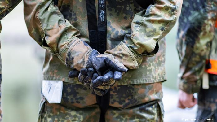 A close-up of German soldier with his hands behind his back