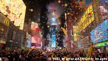 Confetti flies in the air at Times Square to mark the New Year in New York City on January 1, 2022. (Photo by Yuki IWAMURA / AFP) (Photo by YUKI IWAMURA/AFP via Getty Images)