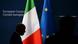 A man walks past flags of Ireland and European Union in Brussels A man walks past flags of Ireland and European Union in Brussels