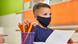 Boy at a desk in a classroom with a face mask Boy at a desk in a classroom with a face mask