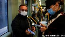 A Carabiniere checks a passenger's coronavirus disease (COVID-19) health pass, known as a Green Pass, aboard a tram the day the government restricts access of unvaccinated to indoor venues, in Rome, Italy December 6, 2021. REUTERS/Yara Nardi
