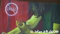 A wall painting in Karachi showing someone injecting drugs