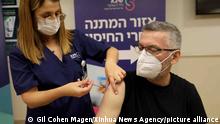 (211231) -- RAMAT GAN, Dec. 31, 2021 (Xinhua) -- A man receives a fourth dose of COVID-19 vaccine at Sheba Medical Center in central Israeli city of Ramat Gan on Dec. 31, 2021. The Israeli Ministry of Health on Thursday night said it has approved the administration of the fourth booster vaccine shot against COVID-19 for the adults at high risk. (Photo by Gil Cohen Magen/Xinhua)