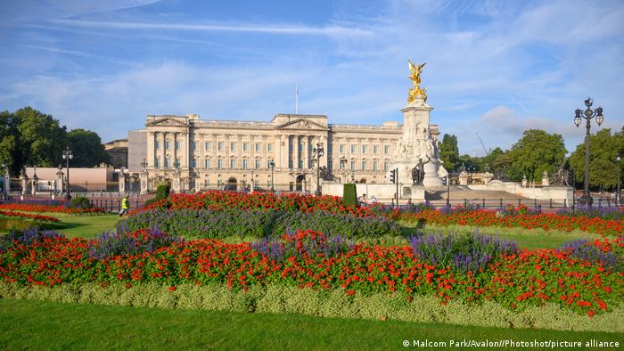 View of the front of Buckingham Palace and Memorial Gardens in bloom, London, UK