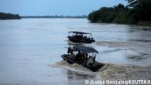 FILE PHOTO: Colombian soldiers patrol by boat on the Arauca River, at the border between Colombia and Venezuela, as seen from Arauquita, Colombia March 28, 2021. REUTERS/Luisa Gonzalez/File Photo