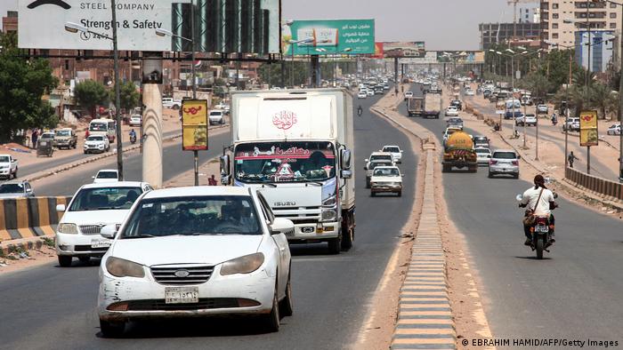 Vehicles drive along a main road in the south of Sudan's capital Khartoum on September 22, 2021.