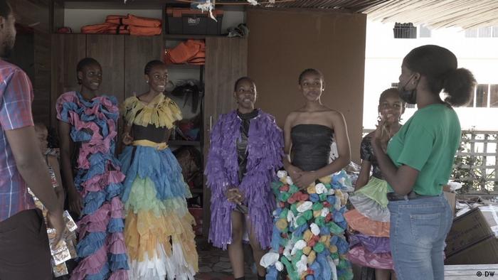 Young women in dresses made out of plastic waste