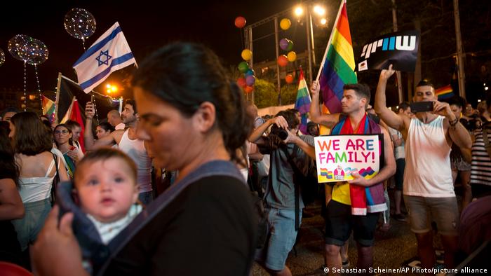  Israelis wave flags and hold signs during a rally to protest against inequality for the LGBT community in Tel Aviv, Israel