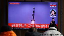 People watch a TV broadcasting file footage of a news report on North Korea firing a ballistic missile off its east coast, in Seoul, South Korea, January 5, 2022. REUTERS/Kim Hong-Ji