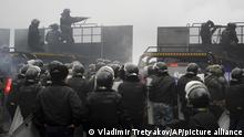 Riot police block a street to stop demonstrators during a protest in Almaty, Kazakhstan, Wednesday, Jan. 5, 2022. Demonstrators denouncing the doubling of prices for liquefied gas have clashed with police in Kazakhstan's largest city and held protests in about a dozen other cities in the country. (AP Photo/Vladimir Tretyakov)