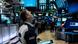 A trader at the New York stock exchange looks up at a screen A trader at the New York stock exchange looks up at a screen