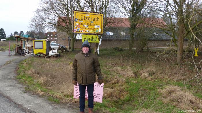 Eckhardt Heukamp standing by the village entry