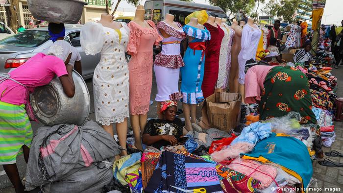 Women selling clothes on the roadside.