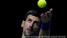 Serbia's Novak Djokovic serves a ball to Croatia's Marin Cilic during their Davis Cup tennis semi-final match at Madrid Arena in Madrid, Spain, Friday, Dec. 3, 2021. (AP Photo/Bernat Armangue)