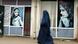 Perempuan Afganistan melintasi toko pakaian di Kabul Perempuan Afganistan melintasi toko pakaian di Kabul