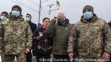 European Union foreign policy chief Josep Borrell, center right, visits the Stanitsa Luganskaya border crossing between Ukraine and the territory controlled by pro-Russian militants in the Luhansk region, Ukraine, Wednesday, Jan. 5, 2022. (AP Photo/Andriy Dubchak)