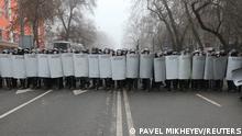 Kazakh law enforcement officers block a street during a protest triggered by fuel price increase in Almaty, Kazakhstan January 5, 2022. REUTERS/Pavel Mikheyev