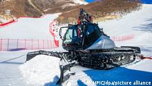 A snow plough clears snow at the National Alpine Skiing Center in the Yanqing District