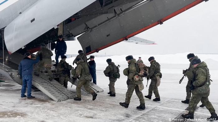 Russian paratroopers board a plane before being sent to Kazakhstan