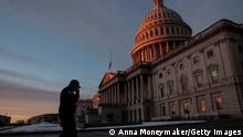 WASHINGTON, DC - JANUARY 06: A U.S. Capitol Police Officer walks past the U.S. Capitol Building during the sunrise on January 06, 2022 in Washington, DC. One year ago, supporters of President Donald Trump attacked the U.S. Capitol Building in an attempt to disrupt a congressional vote to confirm the electoral college win for Joe Biden. (Photo by Anna Moneymaker/Getty Images)