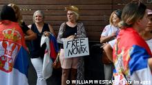 TOPSHOT - Members of the local Serbian community gather outside a hotel where Serbia's tennis champion Novak Djokovic is reported to be staying in Melbourne on January 6, 2022, after Australia said it had cancelled the entry visa of Djokovic, opening the way to his detention and deportation in a dramatic reversal for the tennis world number one. (Photo by William WEST / AFP) (Photo by WILLIAM WEST/AFP via Getty Images)