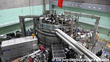 (210528) -- HEFEI, May 28, 2021 (Xinhua) -- Staff members perform an upgrade to the experimental advanced superconducting tokamak (EAST) at the Hefei Institutes of Physical Science under the Chinese Academy of Sciences (CAS) on April 13, 2021. Chinese scientists have set a new world record of achieving a plasma temperature of 120 million degrees Celsius for a period of 101 seconds in the latest experiment on Friday, a key step toward the test running of a fusion reactor. The experiment at the experimental advanced superconducting tokamak (EAST), or the Chinese artificial sun, also realized a plasma temperature of 160 million degrees Celsius, lasting for 20 seconds. (Xinhua/Liu Junxi)