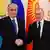 Kassym-Jomart Tokayev (left) and Vladimir Putin shake hands
