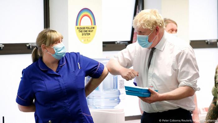 Boris Johnson greating medical staff with his elbow at a COVID-19 vaccination center in Northampton