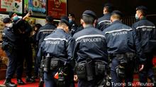 FILE PHOTO: Police are seen outside the Stand News office building, after six people were arrested for conspiracy to publish seditious publication according to Hong Kong's Police National Security Department, in Hong Kong, China, December 29, 2021. REUTERS/Tyrone Siu/File Photo