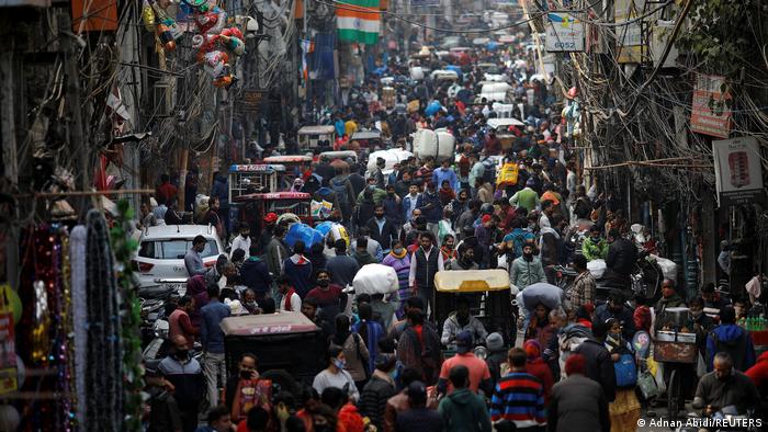People shop at a crowded market in Delhi