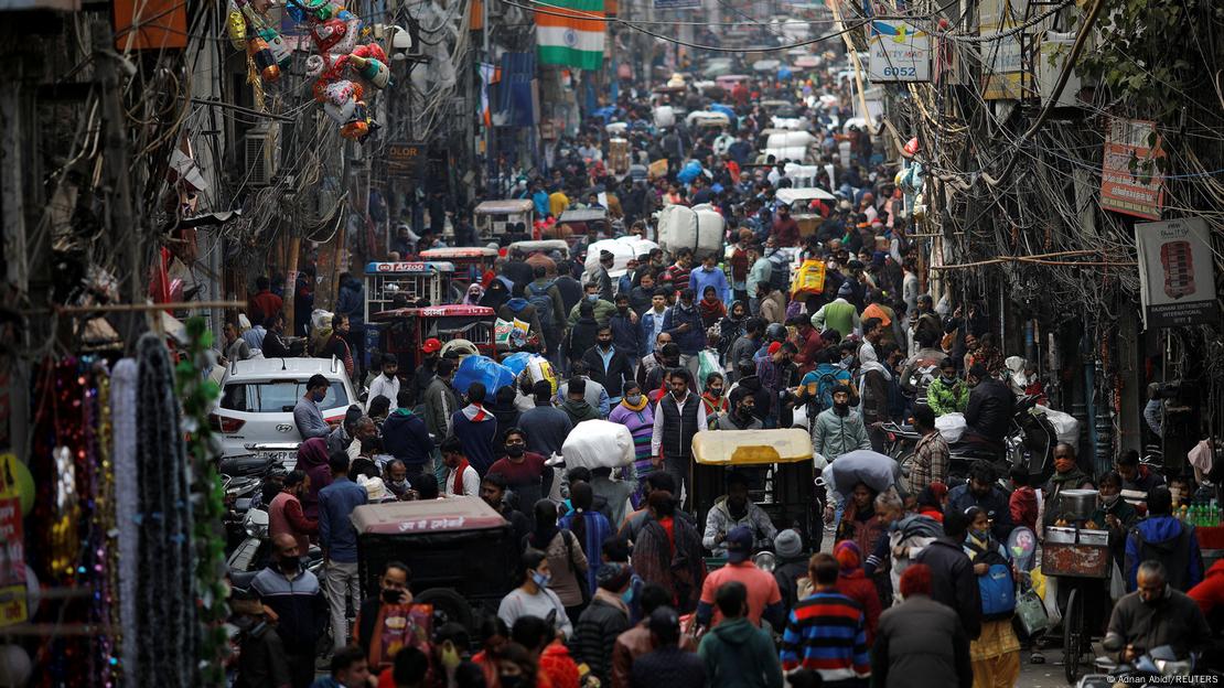 People shop at a crowded market in the old quarters of New Delhi, India