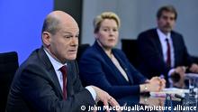 German Chancellor Olaf Scholz, left, and Berlin's Mayor Franziska Giffey address a press conference following a meeting with the heads of government of Germany's federal states at the Chancellery in Berlin on Friday Jan. 7, 2022. (John MacDougall/Pool via AP)