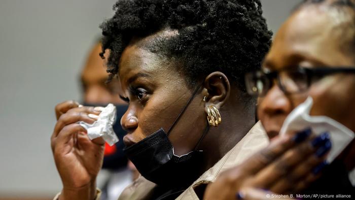 Ahmaud Arbery's sister Jasmine Arbery wipes a tear from her eyes while at a sentencing hearing for her brother's killers in Brunswick, Georgia