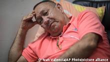 Victor Escobar sits at his home during an interview in Cali, Colombia, Thursday, Jan. 6, 2022. Escobar, who suffers chronic obstructive pulmonary disease, oxygen dependence, lack of muscle control and secondary effects from a stroke is scheduled on the evening of Jan. 7 to become the first person to receive euthanasia legally, without being a terminally ill patient. Euthanasia for terminally ill patients is legal in Colombia. (AP Photo/Ivan Valencia)