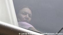 A person believed to be Renata Voracova, a tennis player from the Czech Republic, looks out of a window at the Park hotel immigration detention centre in Melbourne, Australia, Saturday, Jan. 8, 2022. Voracova, who has already played in a warm-up tournament in Melbourne, was being detained in the same immigration hotel as Serbian tennis star Novak Djokovic but is believed to be leaving the country later today. (James Ross/AAP Image via AP)