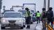 Kazakh law enforcement officers stand guard at a checkpoint on a road in Nur-Sultan Kazakh law enforcement officers stand guard at a checkpoint on a road in Nur-Sultan