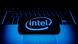 Intel logo displayed on a phone screen and a laptop keyboard Intel logo displayed on a phone screen and a laptop keyboard