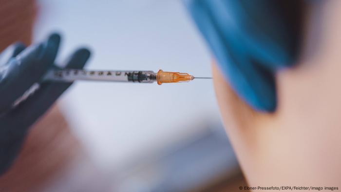 A woman receives a dose of the BioNTech-Pfizer vaccine from her general doctor in Kaprun, Austria