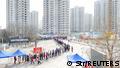 People line up outdoors for nucleic acid testing during a citywide mass testing in Tianjin