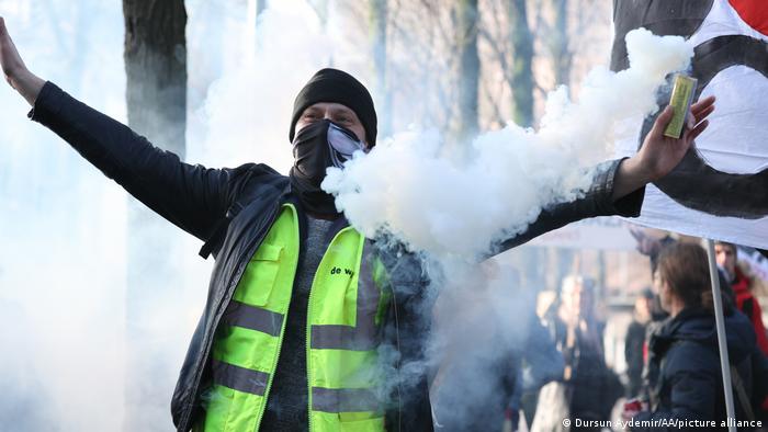A man stretches out his arms during a protest against COVID curbs in Brussels, Belgium