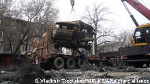 A crane loads a military truck, which was burned during clashes onto the platform in Almaty, Kazakhstan, Sunday, Jan. 9, 2022. Kazakhstan's health ministry says at least 164 people have been killed in protests that have rocked the country over the past week. President Kassym-Jomart Tokayev's office said Sunday that order has stabilized in the country and that authorities have regained control of administrative buildings that were occupied by protesters, some of which were set on fire. (Vladimir Tretyakov/NUR.KZ via AP)