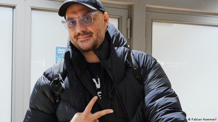 Kirill Serebrennikov on his arrival in Hamburg, wearing a baseball cap and glasses.