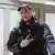 Kirill Serebrennikov on his arrival in Hamburg, wearing a baseball cap and glasses.