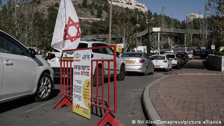 Drivers queue at a COVID-19 test center in Jerusalem