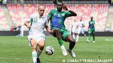 Algeria's forward Sofiane Feghouli (L) fights for the ball with Sierra Leone's midfielder John Kamara during the Group E Africa Cup of Nations (CAN) 2021 football match between Algeria and Sierra Leone at Stade de Japoma in Douala on January 11, 2022. (Photo by CHARLY TRIBALLEAU / AFP)
