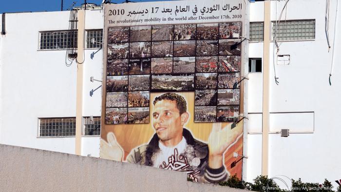 A memorial shows Mohamed Bouazizi, a Tunisian street vendor who set himself on fire on 17 December 2010 and became a catalyst for the Tunisian Revolution.