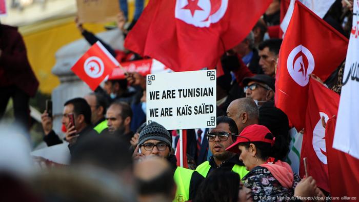Supporters of Tunisian President Kais Saied endorse his decision to further freeze parliament until the new legislative elections on December 17, 2022.
