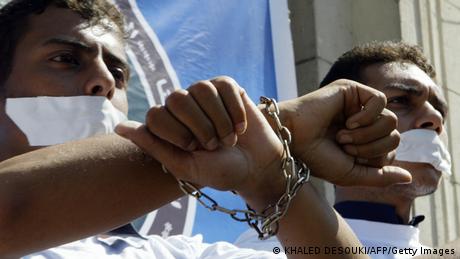 Men with chained wrists 