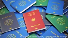 Passport of Germany on the pile of different passports. Immigration concept. 3d