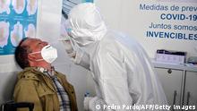 A health worker takes a COVID-19 nasal sample from a passenger, at Benito Juarez international airport in Mexico City, on January 8, 2022. - The Central American nation recorded 28,023 new infections on the eve, the second highest since the start of the pandemic, for a total of more than four million cases. Mexico has officially recorded 300,101 deaths since March 2020, including 168 in the last 24 hours, the health ministry said. (Photo by PEDRO PARDO / AFP) (Photo by PEDRO PARDO/AFP via Getty Images)